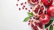   A cluster of pomegranates against a pristine white backdrop, accompanied by their green leaves atop the fruit