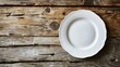 High-resolution image of a sleek white plate on a weathered light wood table, emphasizing rustic elegance and simplicity