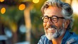 © VISUAL BACKGROUND - A man with glasses and a beard smiling.