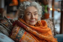 Smiling Elderly Woman With Radiant Eyes Wearing A Bright Orange Scarf