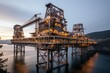 © Elena - A high quality image that captures the industrial infrastructure of an offshore oil rig platform silhouetted against the vast and serene ocean at dusk.