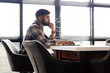 © Wavebreak Media - Asian young professional sitting at desk, looking at laptop in a modern business office