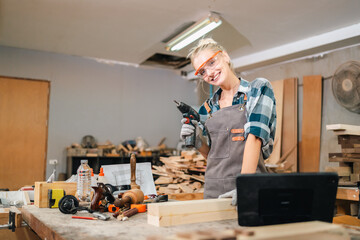 In the carpenter's shop, a professional woman crafts wooden furniture, using tools with skill in her woodwork occupation, showcasing industry prowess.