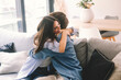 Beautiful young couple hugging in their new apartment. Engaged couples celebrate by hugging each other happily for their new home. Celebrating relationship achievement man and woman indoor leisure
