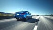 Sleek blue car speeding on a sunlit highway under clear skies. Modern vehicle design, dynamic road travel scene, perfect for automotive ads. AI