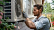 close-up of repairman fixing air conditioner at exterior of house, filters, technician