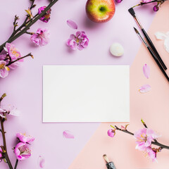 Wall Mural - Blank, white sheet of paper on a pink background with flowers and an apple
