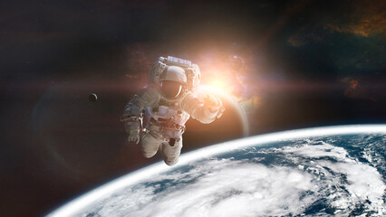 Wall Mural - astronaut in outer space on low-orbit of earth planet with sunlight. elements of this image furnishe