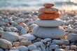 Zen stone stack on a sunlit pebbly beach, portraying balance, peace, and harmony during a sunrise with soft light