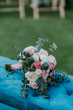© ADDICTIVE STOCK - Elegant bridal bouquet on blue velvet chair