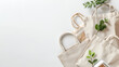 a group of canvas bags with leaves and a cell phone on a white background