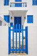 Greek whitewashed house with blue gate in Nikia village on Nisyros island. Greece