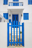 Fototapeta Konie - Greek whitewashed house with blue gate in Nikia village on Nisyros island. Greece