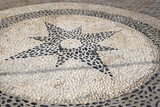 Fototapeta Konie - Greek pebble mosaic on the street in Nikia village. Nisyros island, Greece