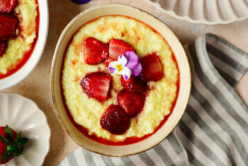 Wall Mural - Creamy millet porridge with baked strawberries in to the bowl