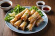 Chicken spring rolls served with fish sauce.