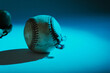 Old used rugged baseball ball in blue color spotlight, copy space on background for sport.