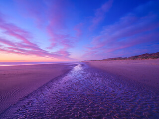 Wall Mural - seascape during sunrise. bright clouds on the sky. lines of sand on the seashore. bright sky during 