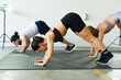 Group of three people doing planks in fitness class