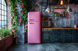 A pink refrigerator stands in a kitchen next to a window, providing a pop of color against the white walls and countertops.