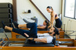 Pilates class with reformer machines in studio
