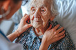 © Microgen - End-of-life or palliative care patient examined by a geriatric nurse