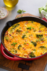 Wall Mural - Healthy frittata or quiche with broccoli and red pepper whole in a cast iron pan