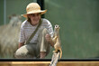 Happy animal lover teenager girl looking at funny Meerkat mongoose