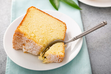 Wall Mural - Lemon pound cake baked in a bundt pan topped with powdered sugar