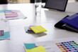 © Wavebreak Media - Colorful sticky notes and app design papers are lying on a table in a modern business office