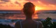 © BrightWhite - Serene woman enjoying vibrant sunset at beach, orange and blue hues, summer tranquility, back view, silhouette, travel and relaxation theme.