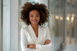 © Aris - Afro businesswoman in white formal suit dress arm cross in modern office