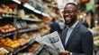 Man smiling with newspaper in market - A joyful man in a suit holds a newspaper in a vibrant grocery store, amidst fruits and vegetables