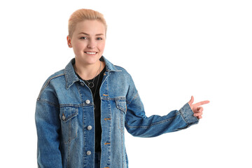 Poster - Young woman with short hair pointing at something on white background