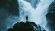 A person stands on a rocky outcrop back turned as they gaze at a magnificent waterfall cascading down a cliff face. The powerful . .