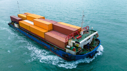 A little small cargo ship carrying container and running on calm sea for shipping express cargo from international sea port to cargo agent concept logistic and service..