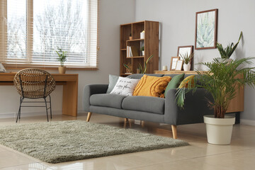 Wall Mural - Interior of stylish living room with sofa, frames and plants