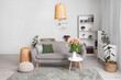 © Pixel-Shot - Interior of modern living room with comfortable sofa, table and flowers