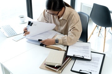 Wall Mural - Middle-aged businesswoman  was sitting and looking at the piles