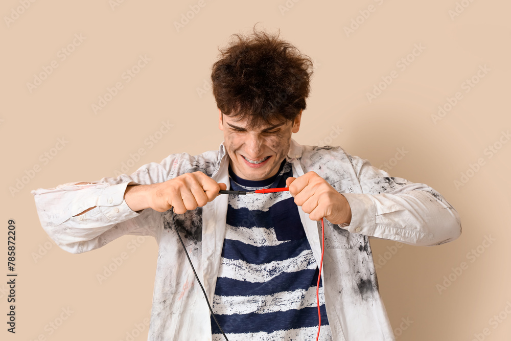 Electrocuted young man with burnt face and wires on beige background