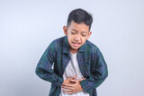 Fototapeta  - Young Boy Touching Belly Feeling Pain, Suffering Stomachache Isolated on White Background