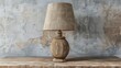 Blank mockup of a farmhousestyle table lamp made of distressed wood and a burlap lampshade. .