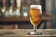 Cold beer in a glass on a wooden table in a pub on a blurred background