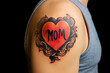 Heart shaped tattoo with text 'MOM' on man's upper arm