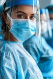 Fototapeta Do przedpokoju - Close-Up of a Female Medical Professional in Protective Gear During a Busy Shift