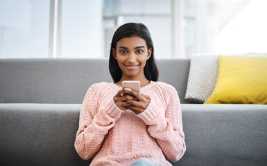 Canvas Print - Portrait, floor and Indian woman in living room with phone for social media, networking or relax. Happy, scroll and girl in lounge on smartphone for communication, online chat or post search in home