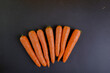 Fresh carrots lie on a black background of isolate