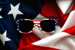 Happy Independence day July 4th. Closeup of USA flag sunglasses on an American flag