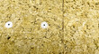 Plastic fastener on the wall of the building holds the mineral wool. Mineral stone wool is attached to the exterior part of the building wall for insulation and protection from external influences