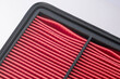 New Red Air Filter Passenger Car Engine Close-up On White Background.